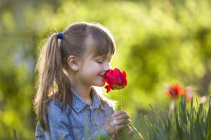 Profile of cute pretty smiling child girl with gray eyes and lon